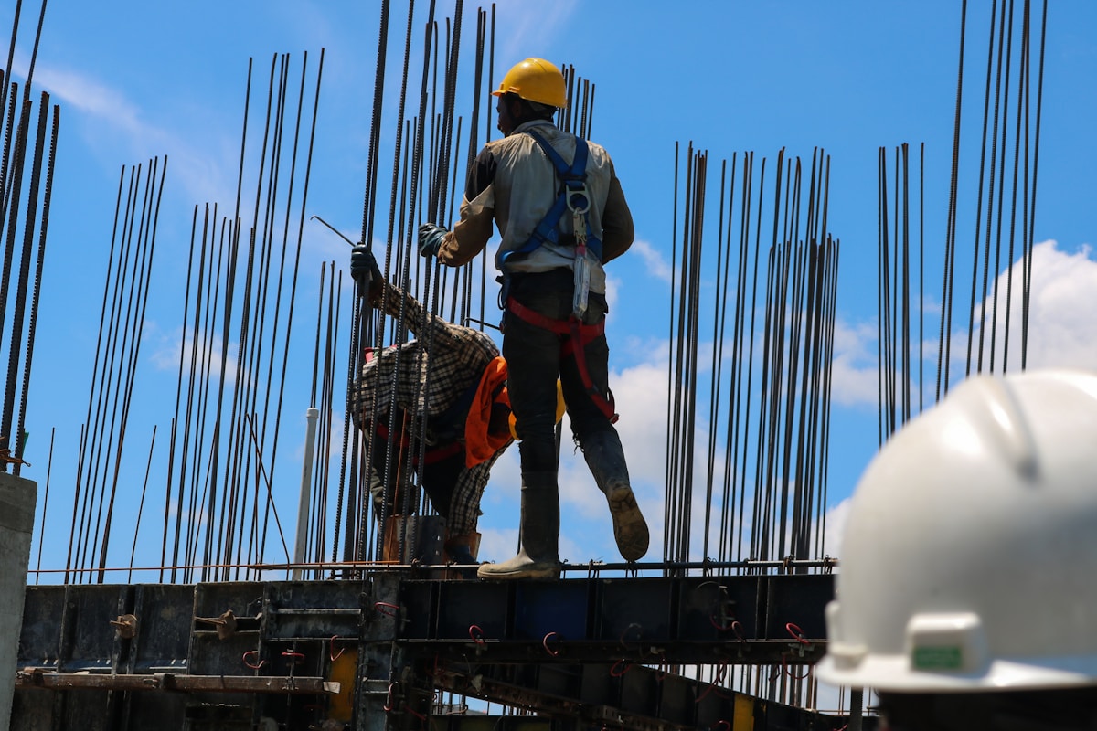 Construction professional on a metal structure at a building site